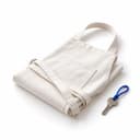 A folded cotton apron beside a single key on a blue loop